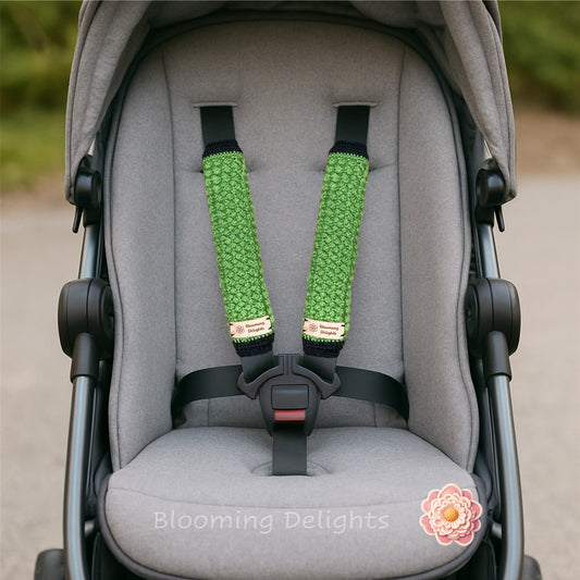 Gray stroller with green and black stroller straps, featuring 'Blooming Delights' branding.