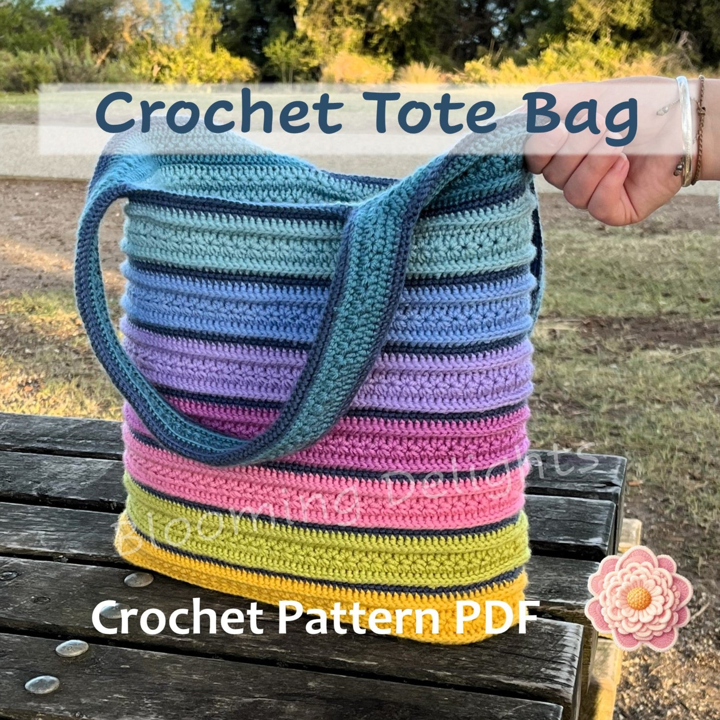 Colorful striped crochet tote bag held by a hand outdoors with text overlay for a crochet pattern PDF.
