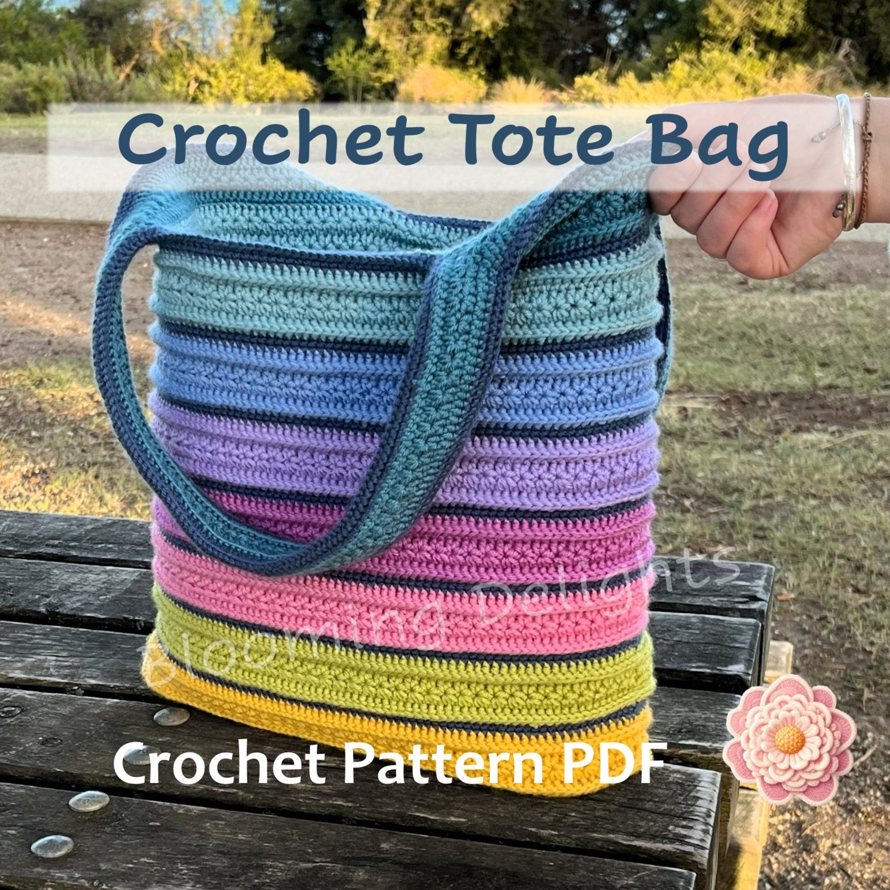 Colorful striped crochet tote bag held by a hand outdoors with text overlay for a crochet pattern PDF.