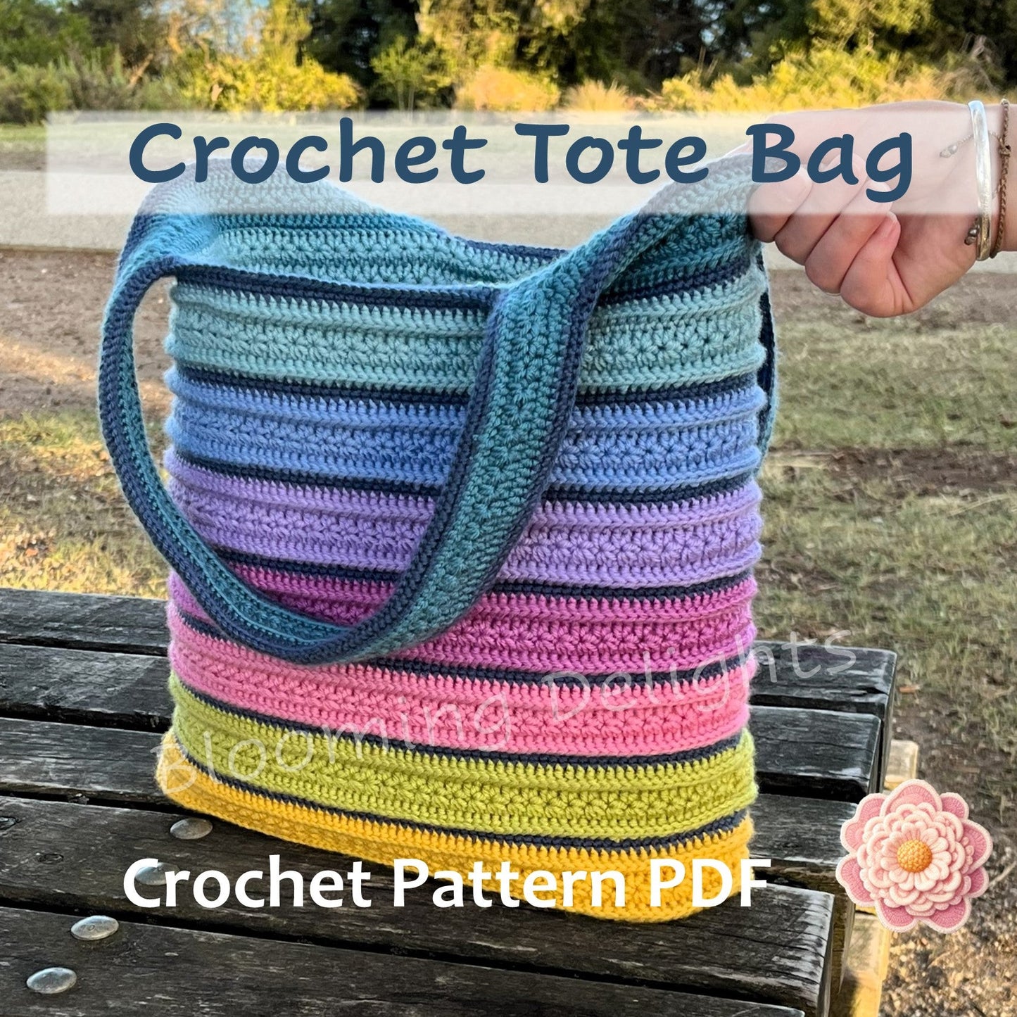 Colorful striped crochet tote bag held by a hand outdoors, with text overlay about a crochet pattern PDF.