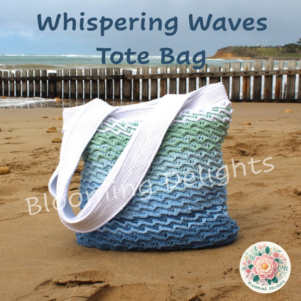 Blue and green tote bag with white strap on a sandy beach
